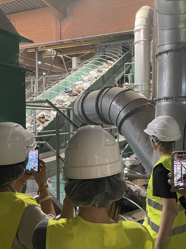 Students observing the waste sorting process