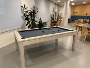 Black pool table in a quiet common area at FTC Paris