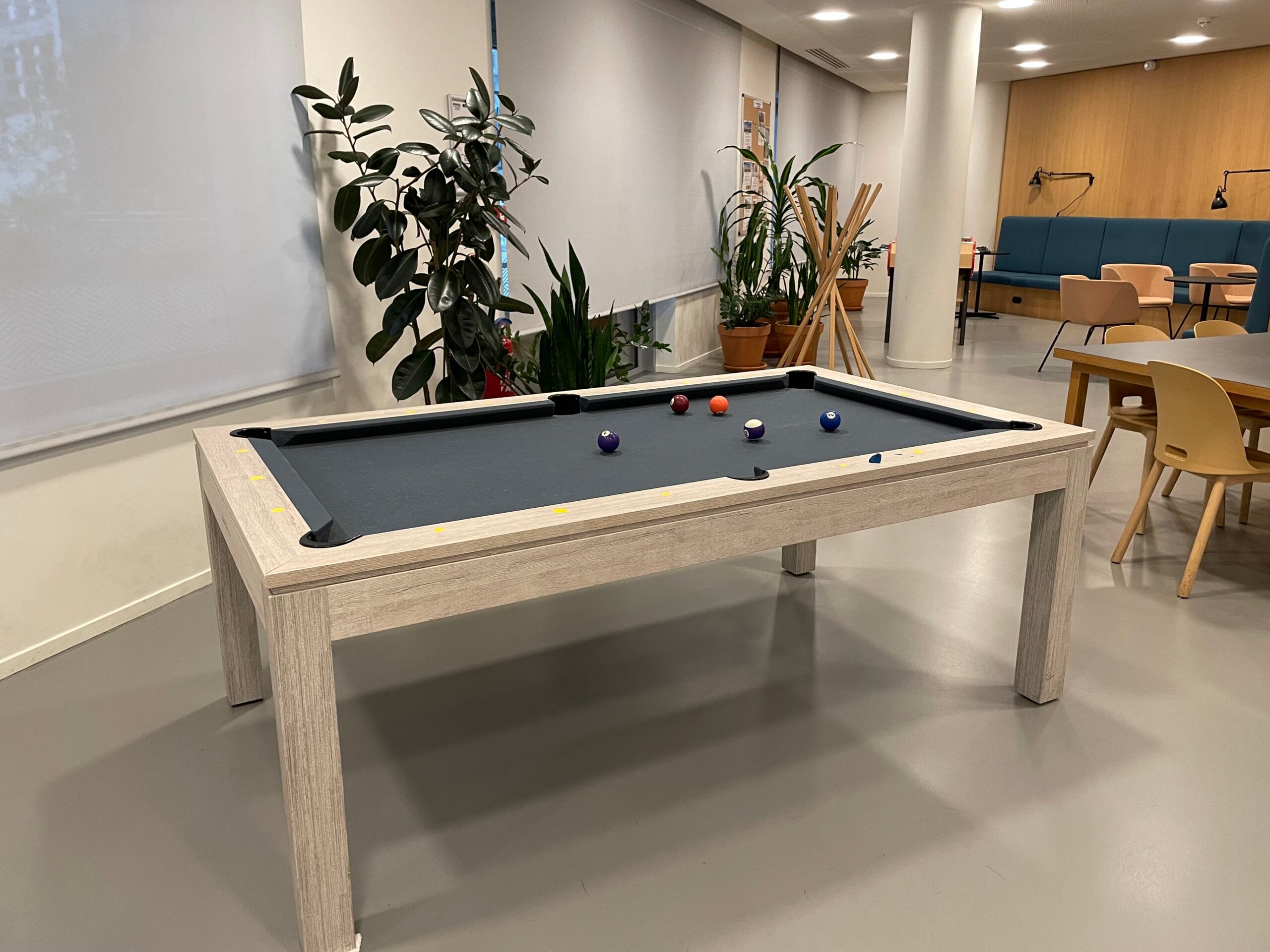 Pool table in the student lounge encouraging conversation and oral practice in a relaxed setting
