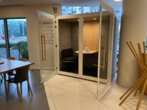 Open wooden office pod with seating for one in FTC’s shared space