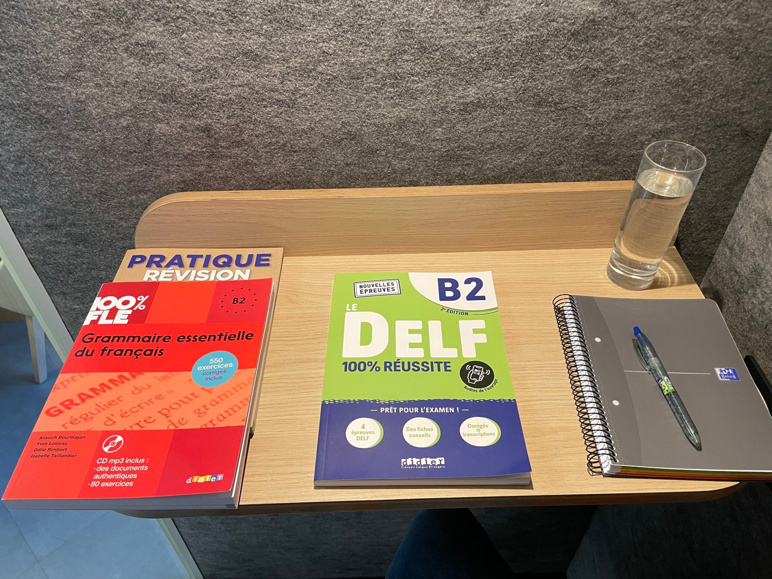 French textbooks for DELF B2 exam and grammar revision in a quiet study booth at FTC Paris