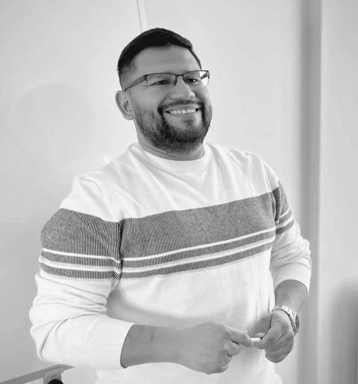 Andres, friendly French teacher, holding a marker in a language classroom