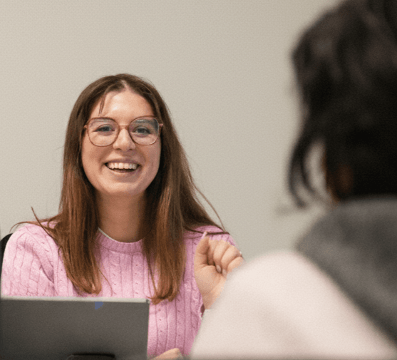 French teacher Mira helping a student practice conversational French.