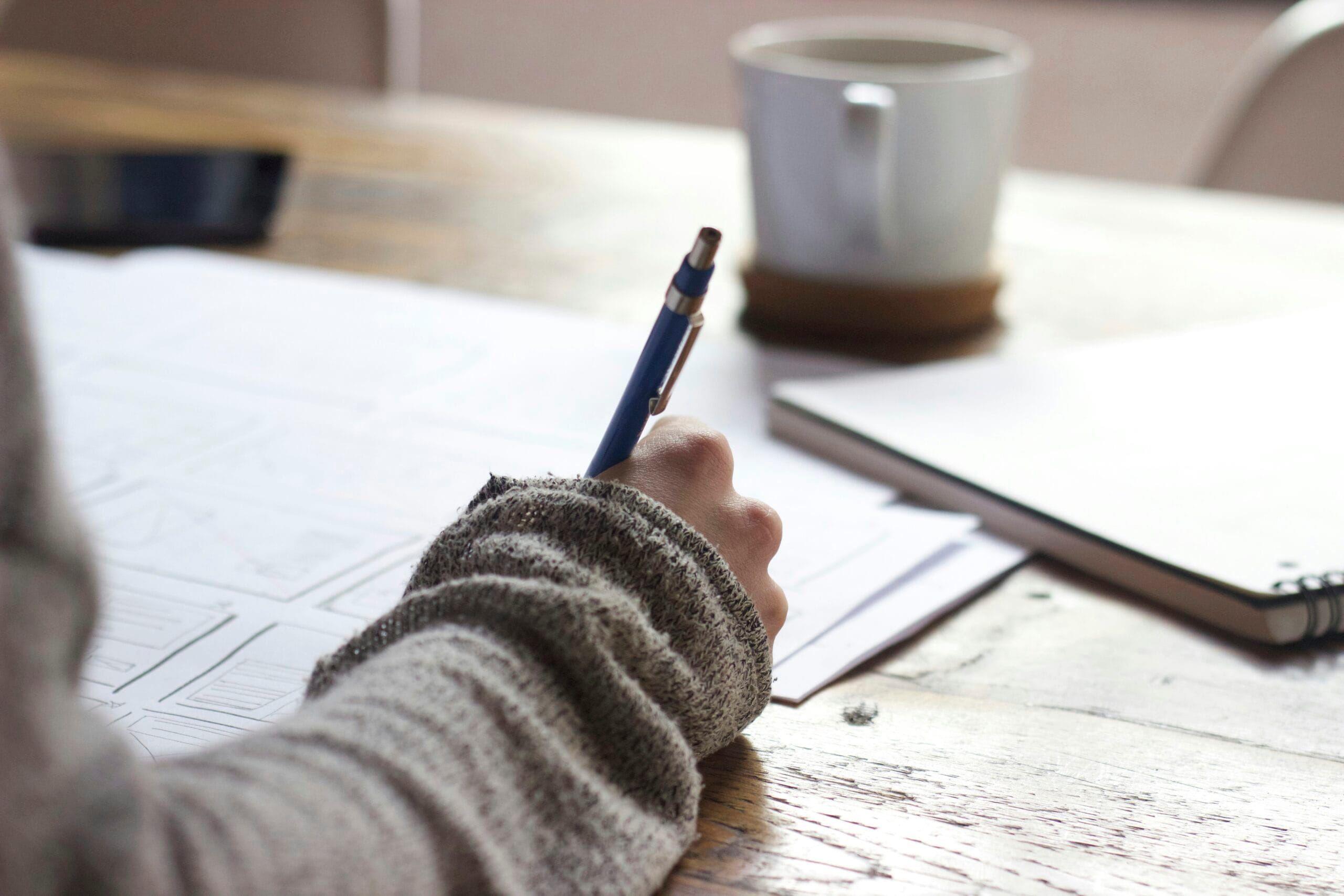 Student taking intensive notes for written exam preparation during a French language course.